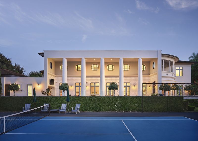 The colonnade and tennis lawn at dusk